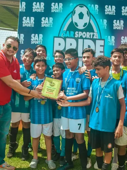 A U-13 team receives their winner's plaque after a dominant tournament performance.