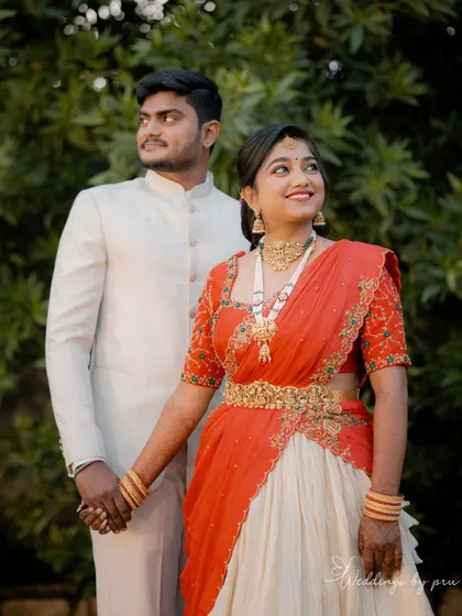 Radiant and glowing! My cherished client Harshitha dazzles on her engagement day in this custom-made red and ivory half saree that I crafted for her in under a week. She looks absolutely stunning.