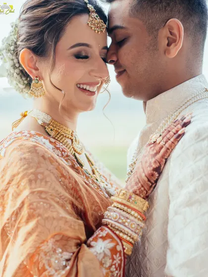 An intimate and joyful close-up. This photo captures the beautiful chemistry between the couple, their smiles telling a story of deep affection and happiness.