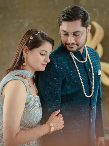 A tender moment between the couple during their Mehendi function. The soft, natural light and their close posture create a romantic and artistic portrait.