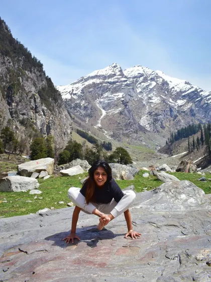 A moment of playful strength with Bhujpidasana (Shoulder-Pressing Pose) in the Himalayas. The stunning mountain backdrop adds to the power of the pose.