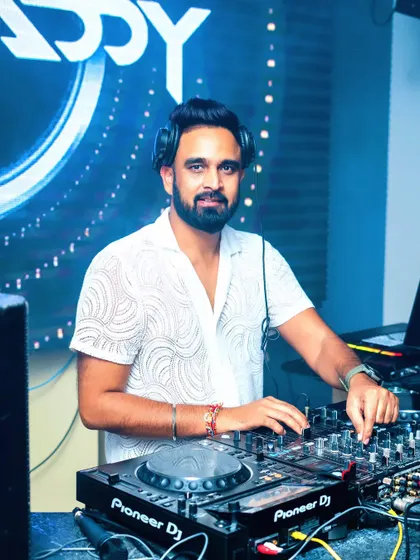 Here I am in my element, focused on the mix with my Pioneer DJ console. A great party is all about seamless transitions and the right track at the right moment, and I use professional gear to deliver just that.
