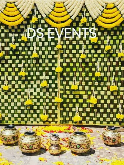 A traditional backdrop made entirely of woven coconut leaves (thenga oolai). I added hanging marigold garlands and decorative pots to create an authentic and rustic look for a South Indian ceremony.