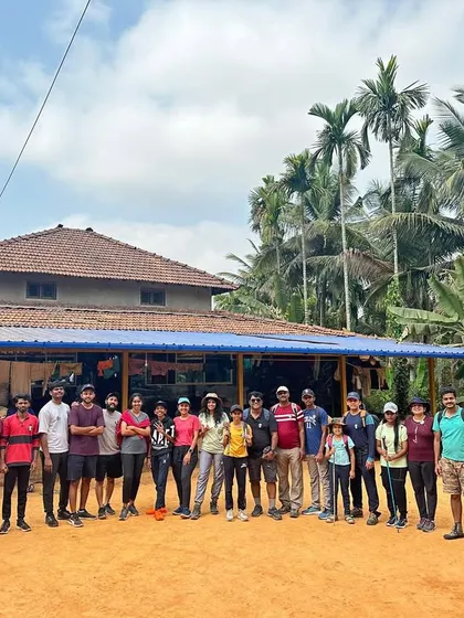 A group photo in front of a rural homestay, our home for the trip.