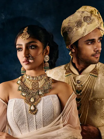 A classic bridal jewellery shot for a campaign. The focus is on the interaction between the couple, while ensuring the intricate details of the necklace, nose ring, and headpiece are perfectly lit.