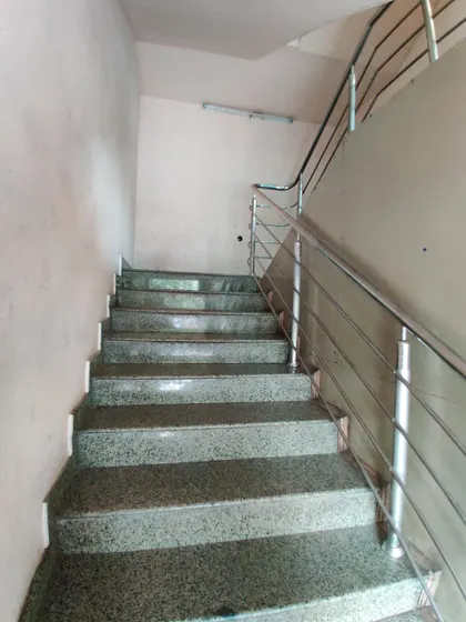 A plain staircase, the blank canvas for our vibrant and artistic intervention.