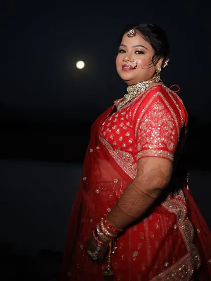 A stunning night shot of the bride. Her makeup remains fresh and radiant, proving its longevity throughout the long wedding day.