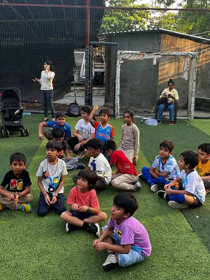 Story time with the coach! Kids sitting and listening intently to the instructions for the next big game.