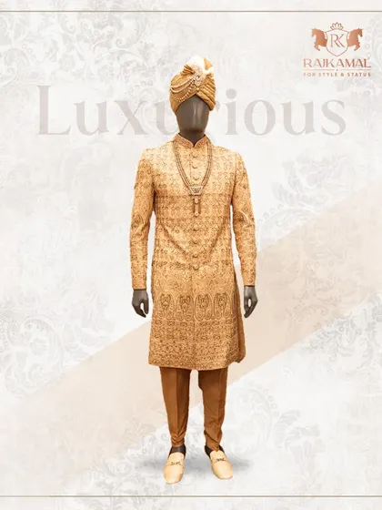 This luxurious golden sherwani is designed for the groom who wants to make a grand entrance. The complete ensemble, including the churidar and traditional footwear, is crafted for a majestic wedding day look.