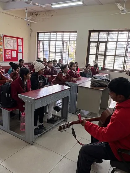A student takes the lead, playing the guitar for his classmates while a fellow facilitates. We encourage peer-to-peer learning and leadership, empowering students to become teachers themselves.