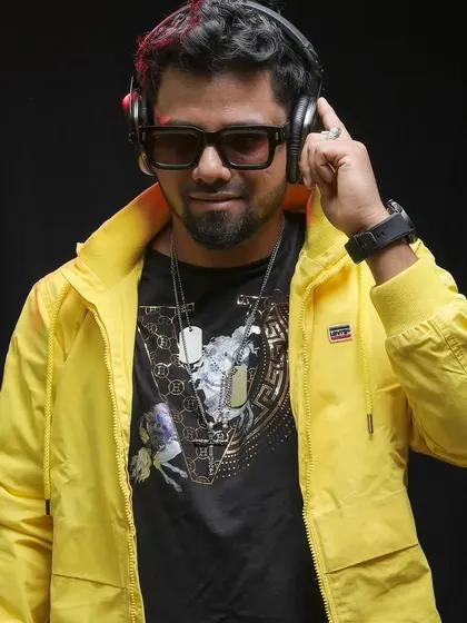 Listening in on the headphones, a classic DJ pose. This yellow jacket is one of my signature looks.