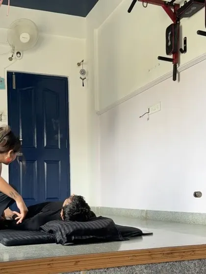 A bodywork session with my husband. I'm applying gentle pressure and stretches to help release tension in his back and hips after a long motorcycle ride.