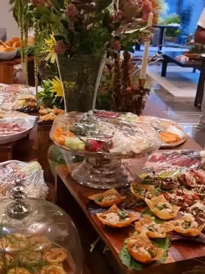Our Bengaluru home setup brings covered platters and open-faced bites together around a floral centrepiece, with food at different heights.