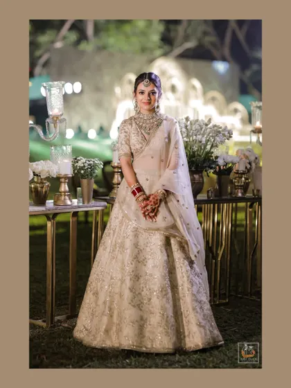 A lovely full-length portrait of the bride at her evening wedding reception.