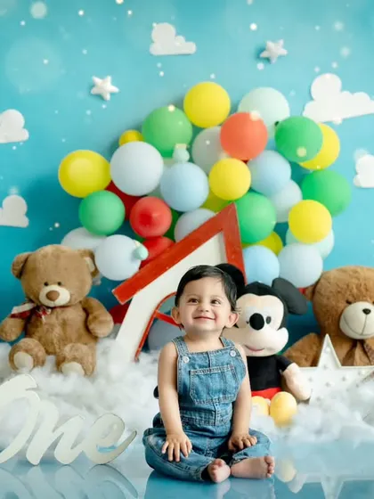 Adventure is out there! This first birthday theme is inspired by the movie 'Up', featuring a house with balloons, fluffy clouds, and teddy bears for a whimsical journey.