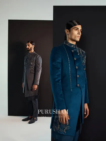 In every stitch, a story to hail. This teal velvet jacket features an asymmetrical cut and delicate gold and silver embroidery, creating a chic statement that is forever in the detail.