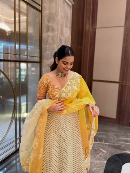 A candid moment showing the flow and feel of this elegant lehenga set. The bright yellow is perfect for a daytime wedding function like a Haldi or Mehendi.