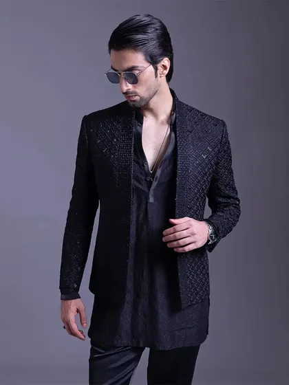 Every detail counts. This black-on-black textured jacket and kurta combination is a story of modern sophistication, perfect for the man with a timeless sense of style.