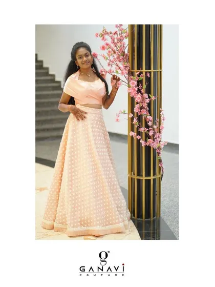 Just peachy! A young client looking beautiful in a custom peach lehenga set. The collared blouse adds a modern touch to the traditional dotted skirt.