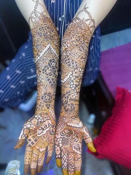 A beautiful bridal henna design with a mix of floral and geometric patterns, creating a unique and modern look.