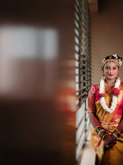 A beautifully composed portrait of the bride, using the window and shadows to create a dramatic and artistic effect.