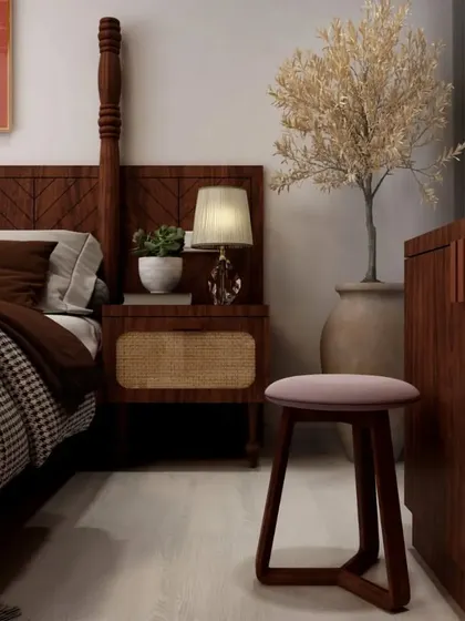 A close-up detail of the bedside area, showing the rattan-fronted nightstand and the quality of the wooden furniture.