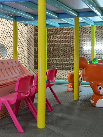 A view of our soft play area, with bear-themed chairs and other toddler-safe equipment, all enclosed within the main structure.