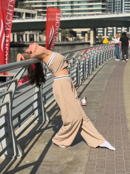 A relaxed, flexible pose against a railing in Dubai. Dance is also about finding moments of quiet expression, and I incorporate this into my more contemporary and soulful routines.