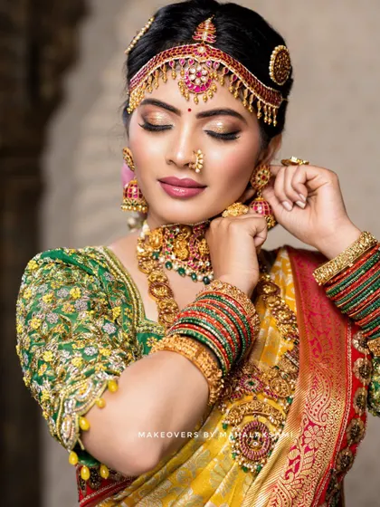 This detailed photoshoot showcases a complete South Indian bridal look, from the intricate matha patti and layered necklaces to the flawless airbrush makeup and traditional saree draping.