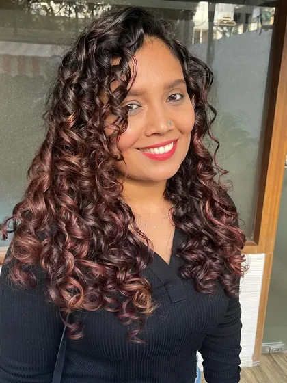Manali looking radiant with her vibrant burgundy curls.