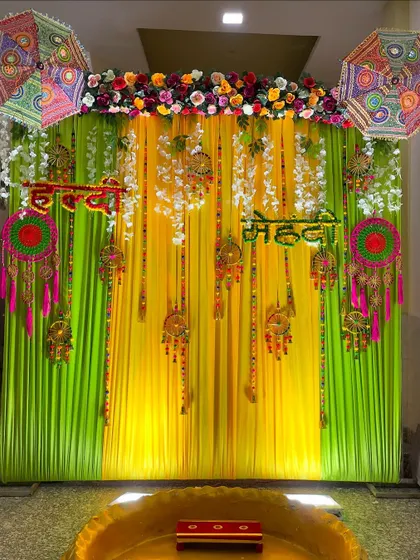 A centered shot of the Haldi-Mehendi backdrop, perfect for placing the ceremonial seating. The setup is bright, festive, and full of traditional details.