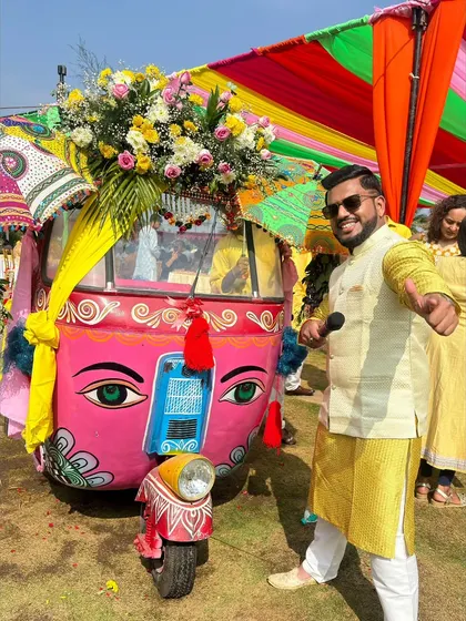 Enjoying the ride. A fun pose with a decorated auto-rickshaw.
