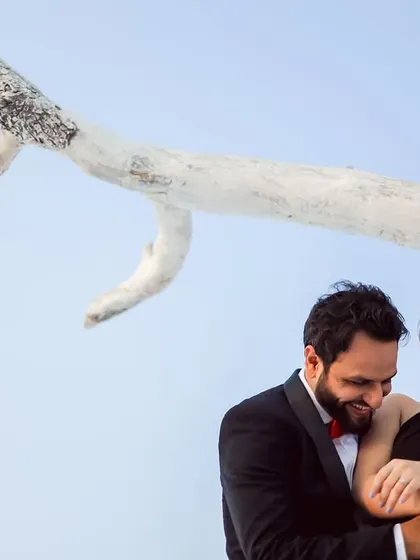 A moment of shared laughter during a stylish pre-wedding shoot. Even in a formal setting, I look for the candid interactions that show the couple's genuine joy and connection.