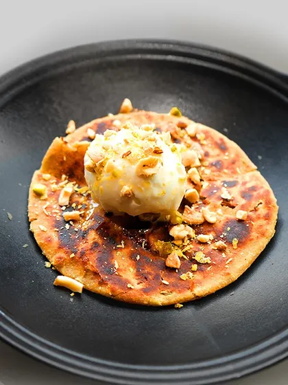 A closer look at the Mawa Mishri Parantha, a sweet, stuffed flatbread topped with a scoop of unique ginger candy ice cream.