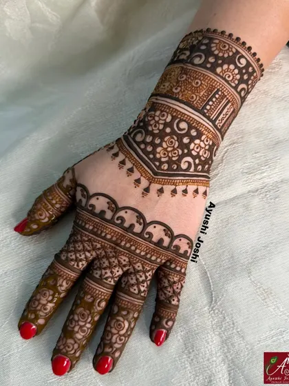 A stylish back-hand design for a bridesmaid, featuring a border of elephants and delicate floral patterns.
