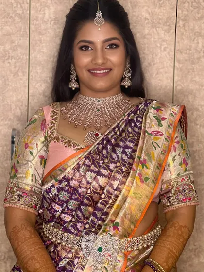 A smiling bride ready for her reception. The makeup is glamorous and celebratory, perfect for an evening of dancing and fun.