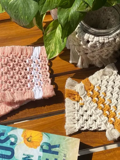 For a more geometric look, we offer these dual-tone square macrame coasters. This photo shows them in both a soft pink and white, and a neutral beige and yellow.