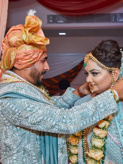 Capturing the key rituals is essential. This shot documents the moment the groom fastens the wedding necklace, symbolizing their union.