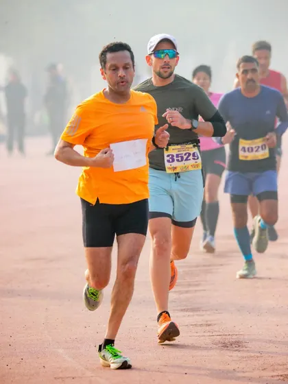A runner showing intense focus during the 10,000m stadium run. This is the "pain face" we talk about, where you dig deep to find your best performance.