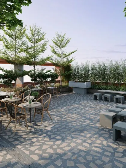 A duplicate view of the rooftop cafe, emphasizing the patterned stone flooring and variety of seating arrangements that cater to both groups and individuals.
