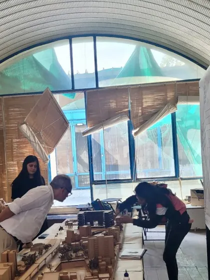 Examining a detailed site model with a student. Understanding the context of a project is the first step towards a sensitive and appropriate design response.