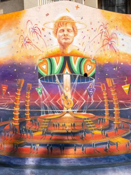 A fantastical mural created in Bandra to announce Ed Sheeran's concert in Mumbai. The artwork depicts the artist on a vibrant, futuristic stage, capturing the energy of a live music event.