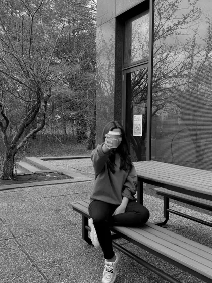 A black and white shot from my last exam day, enjoying a coffee in a comfy sweatshirt.