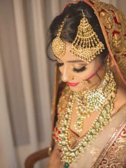 A detailed portrait of a bride, showcasing her magnificent Passa and other traditional jewelry. This shot focuses on the rich cultural elements of her bridal look.