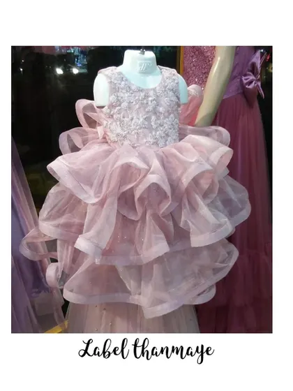 This pink party frock has a beautiful embroidered bodice and a very full, ruffled skirt.