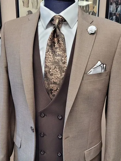 A close-up of a beige suit, showing the beautiful floral tie and double-breasted waistcoat. It shows how accessories can complete the look.