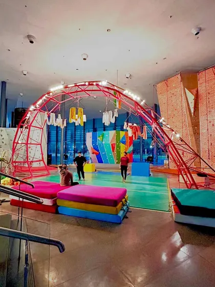 Our gym looks just as awesome after the sun goes down. The lights highlight our unique red arch and colorful climbing walls, creating a cool and energetic vibe for our evening climbing sessions.