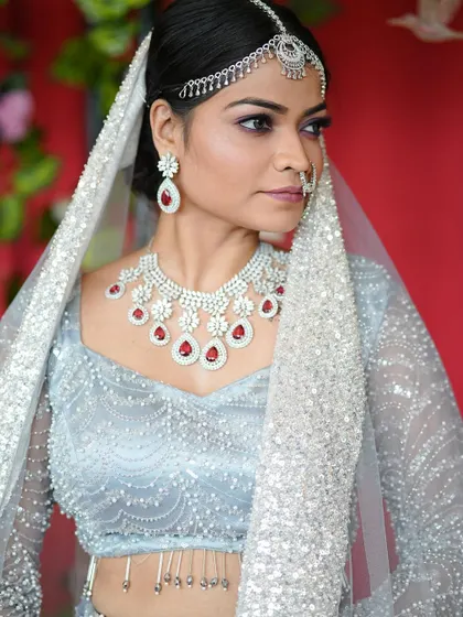 A close-up of the modern bride, highlighting the silver-toned eye makeup with a hint of purple and the perfectly matched diamond jewelry.