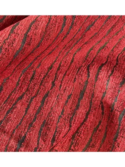 Inspired by ripples in the sand, the 'Ingress' fabric is fluid, vibrant, and alluring. The rich red and black combination creates a decadent and highly textural statement.
