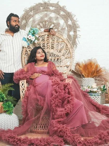 A regal pose in our popular boho studio setup. The large peacock chair and the flowing gown make the mom-to-be look like a queen.